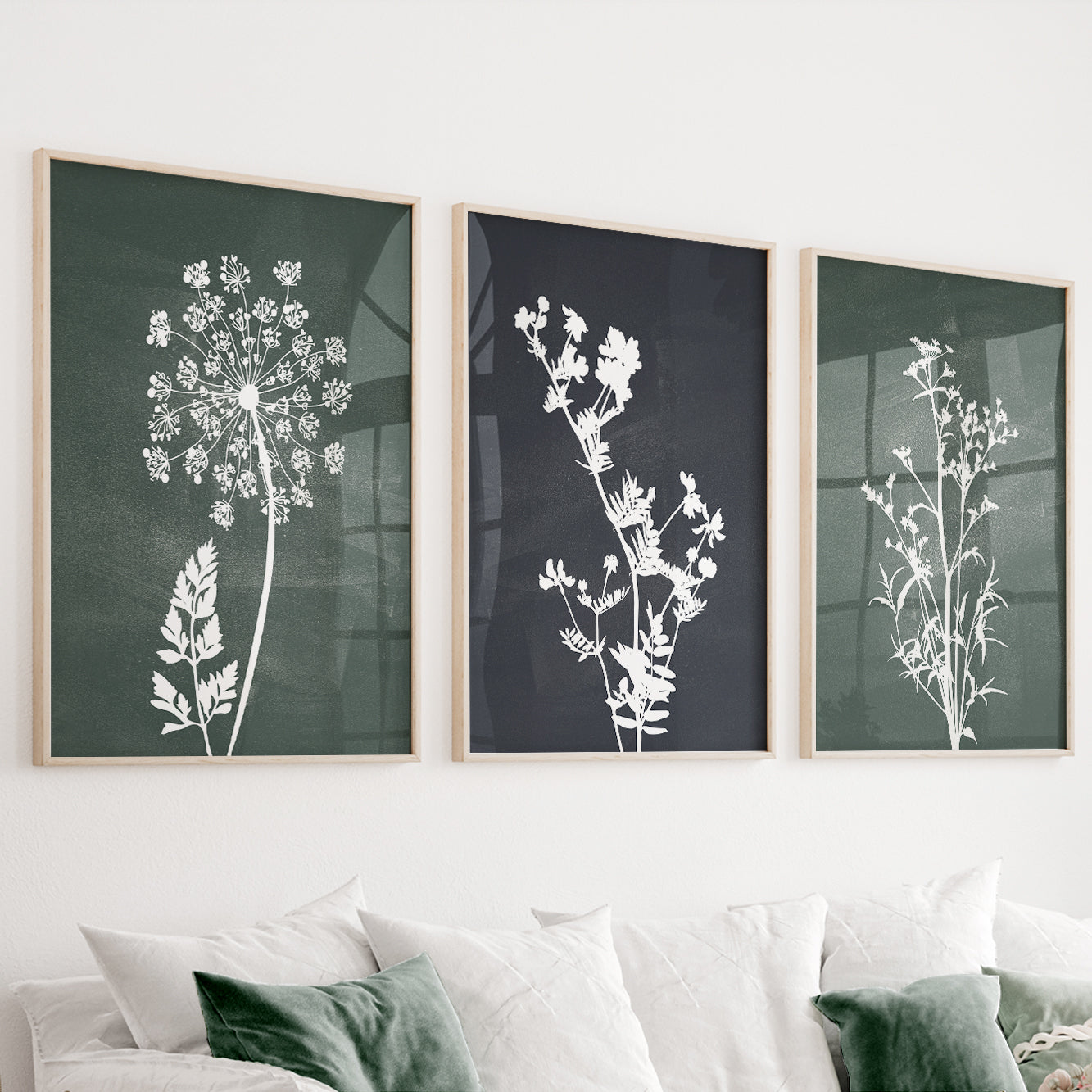 Green botanical wall art set of 3 featuring wildflower silhouettes on deep forest green and charcoal backgrounds