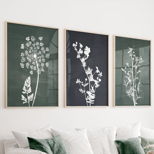 Green botanical wall art set of 3 featuring wildflower silhouettes on deep forest green and charcoal backgrounds