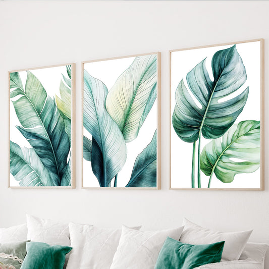 Green botanical wall art set of 3 featuring large tropical leaves in emerald, teal and soft green tones.
