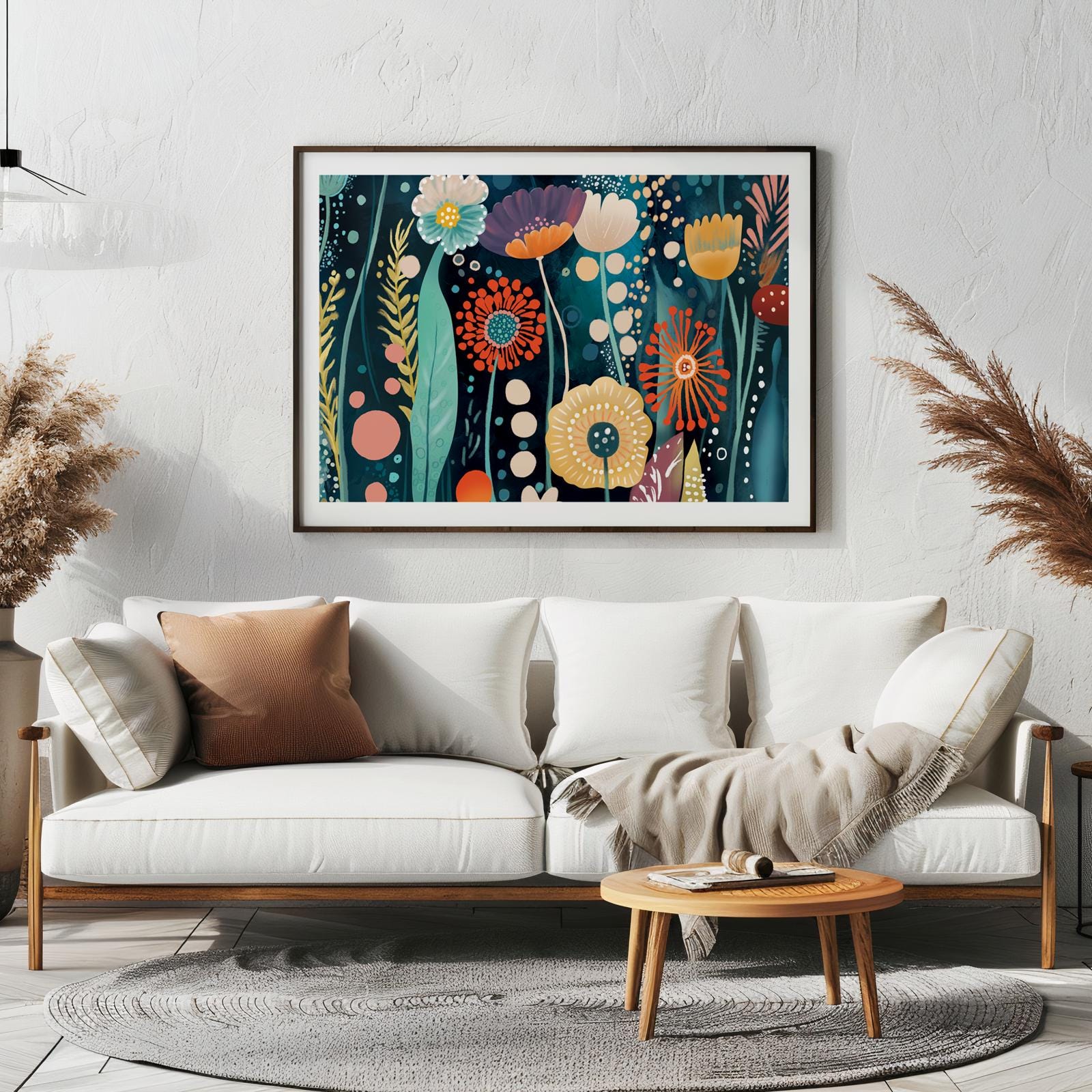Framed abstract floral artwork with vibrant colors displayed above a white sofa