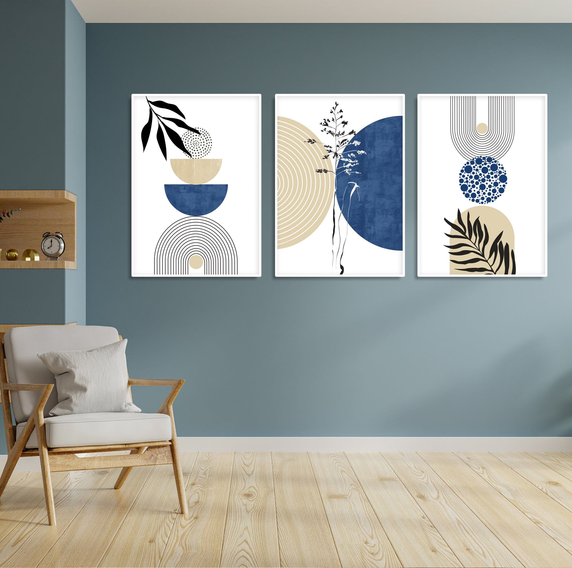 Trio of framed navy and beige geometric prints displayed above a light accent chair.
