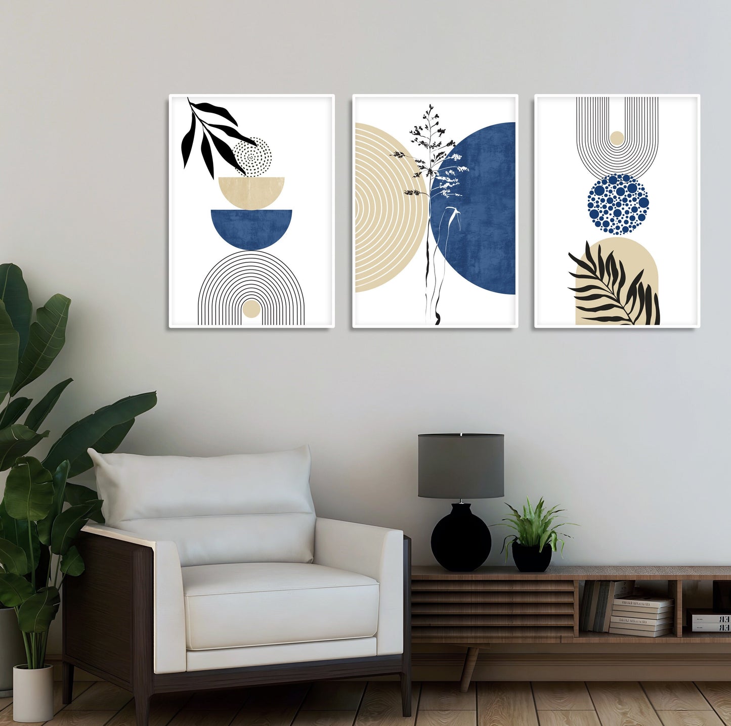 Three navy and beige geometric art prints with abstract botanical motifs framed above a wood console