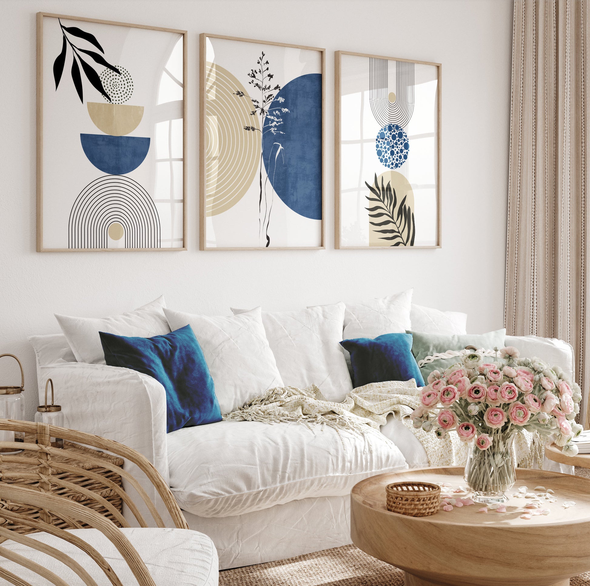 Three-piece navy and beige geometric art set in light wood frames arranged above a sofa
