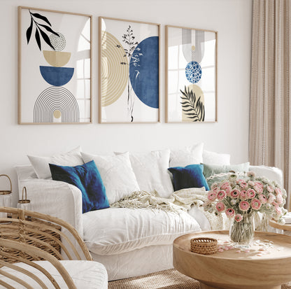 Three-piece navy and beige geometric art set in light wood frames arranged above a sofa