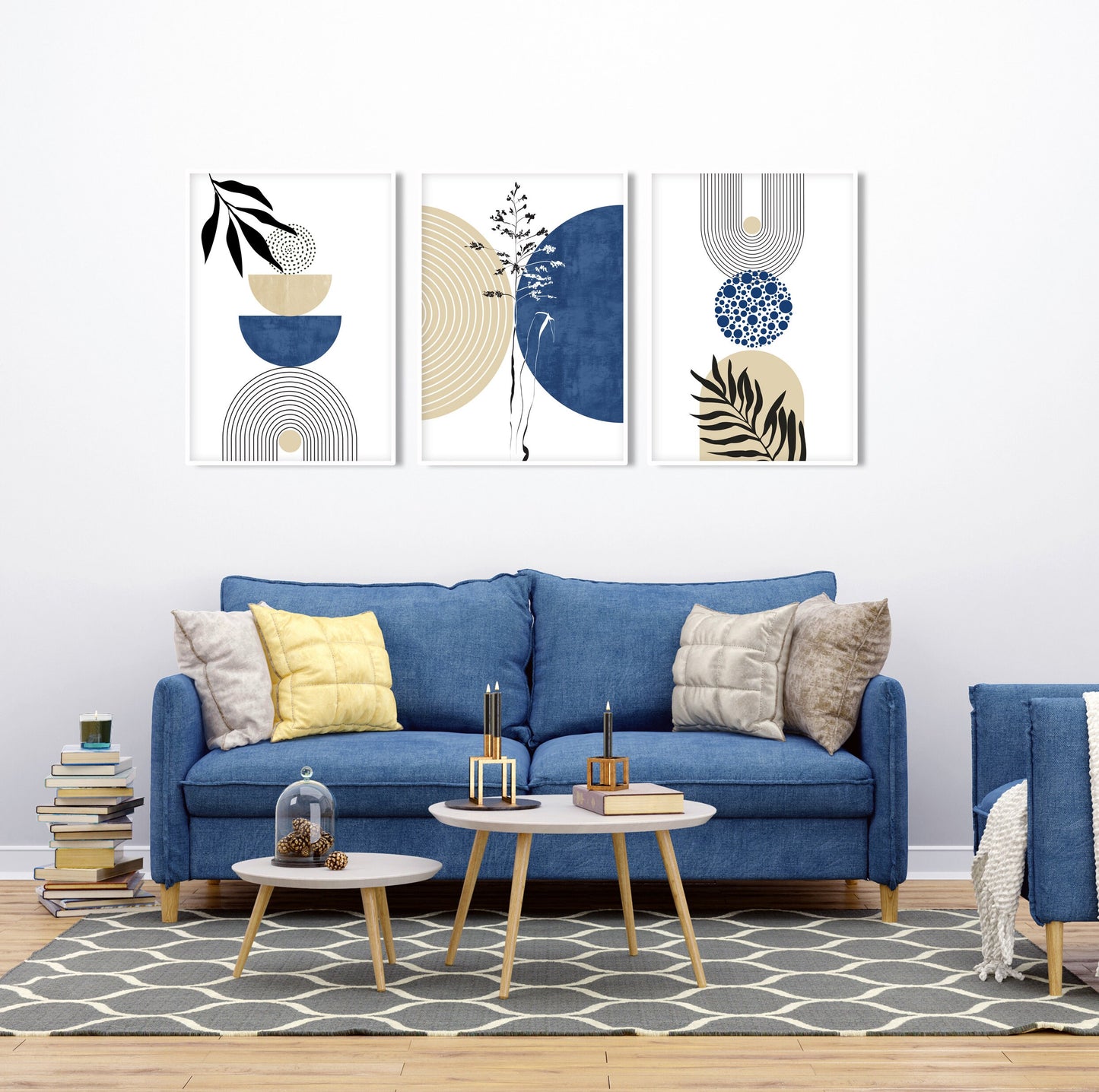Trio of framed navy and beige geometric prints arranged above a blue sofa in daylight