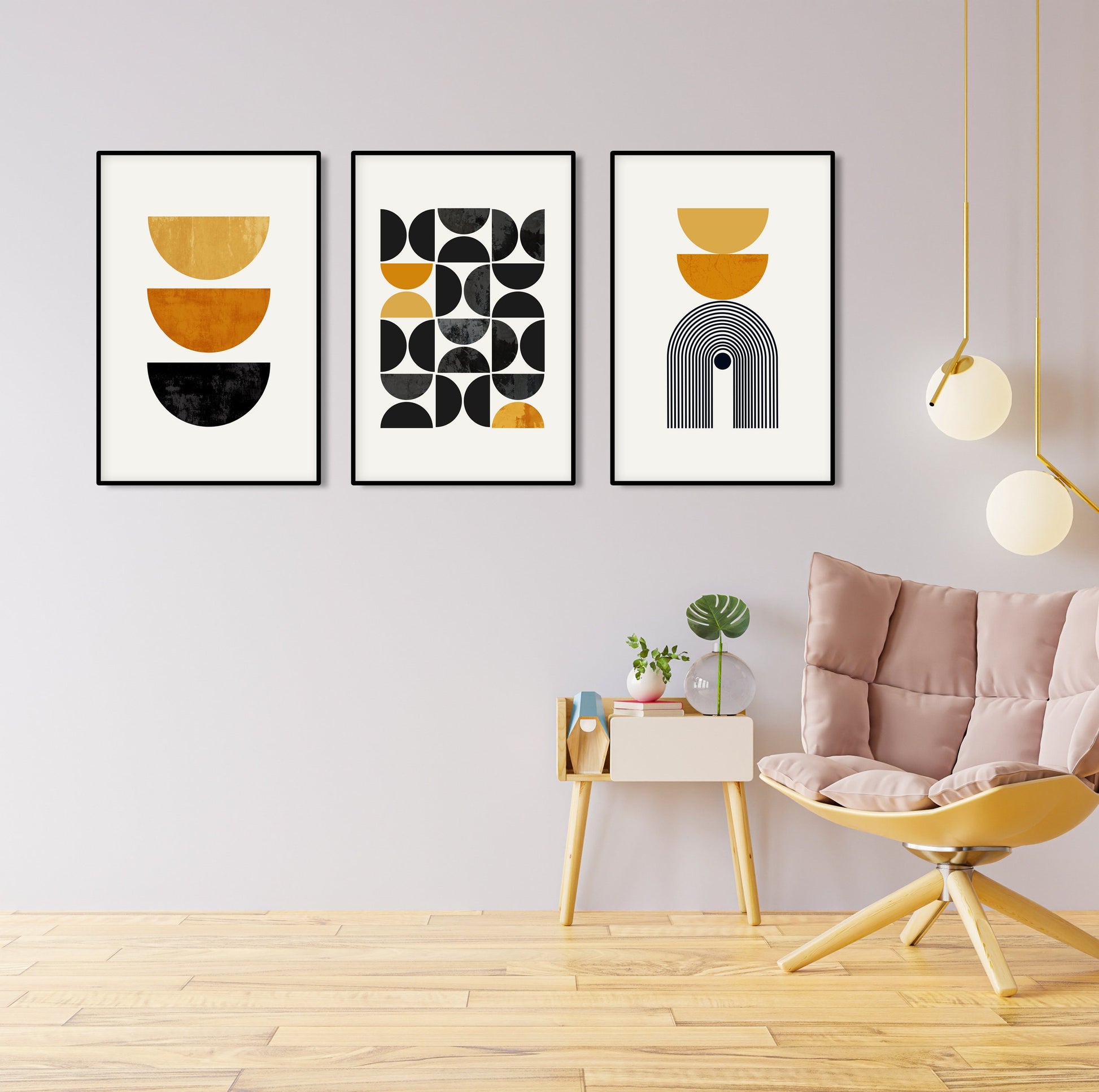Trio of framed geometric prints in mustard yellow and black arranged on a pale wall