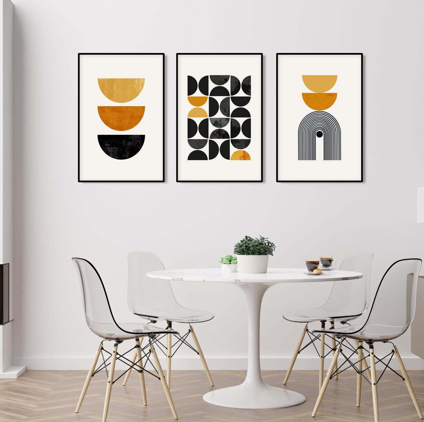 Framed geometric wall art set in three sizes shown above a round dining table setup