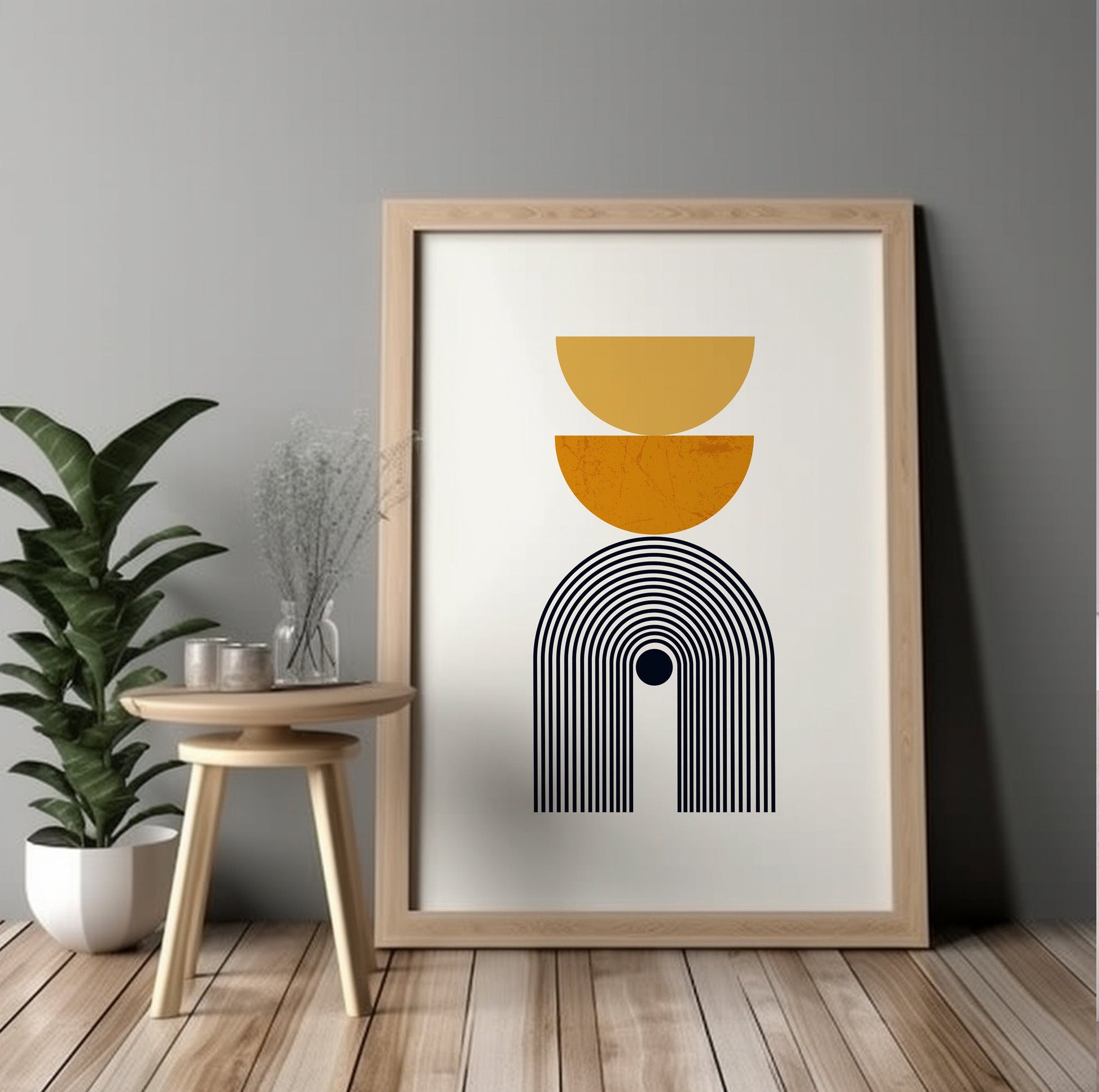 Framed mustard yellow and black geometric print standing against a gray wall, unboxed.