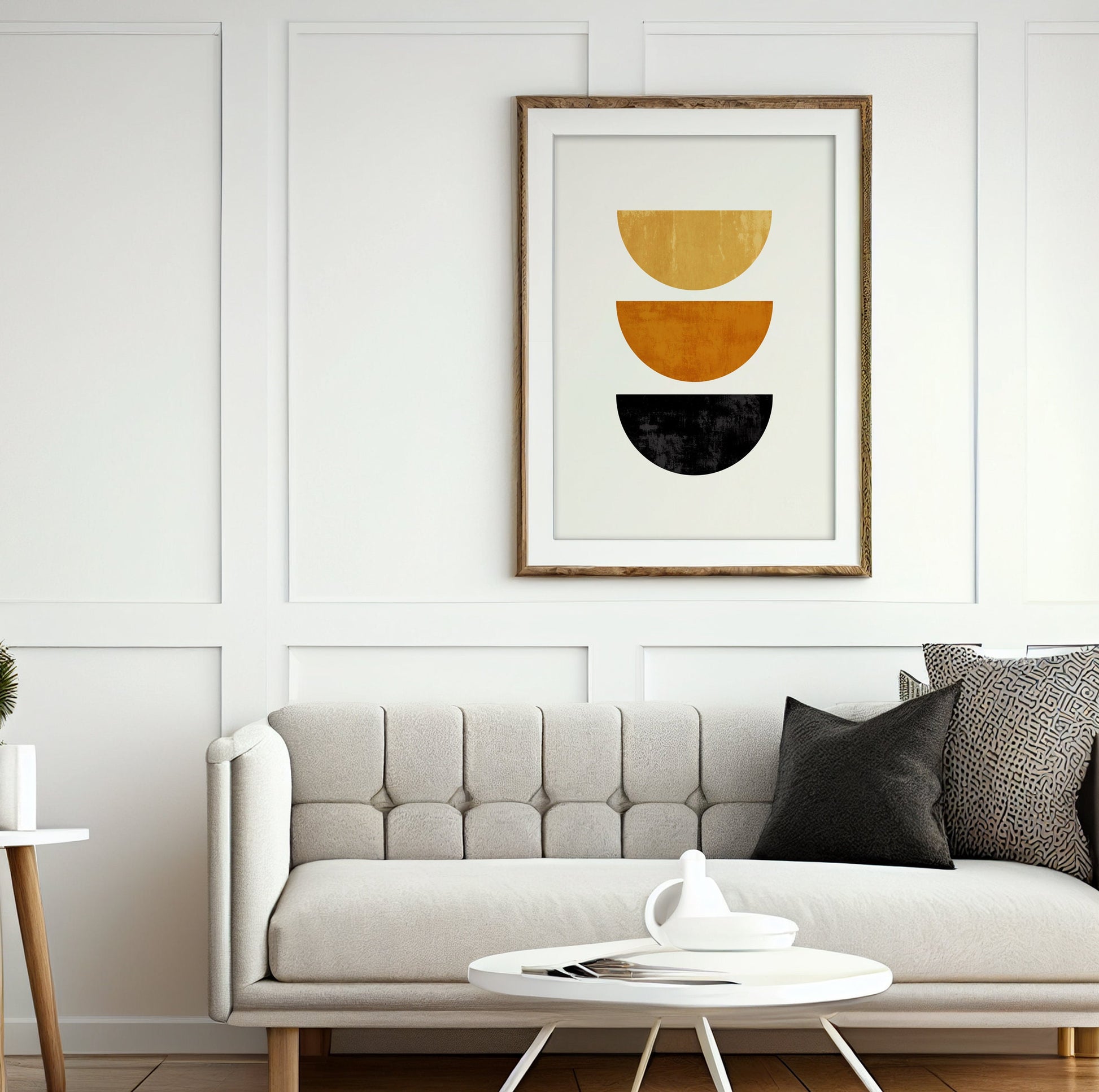 Geometric half-circle print in a wood frame hung above a light tufted sofa