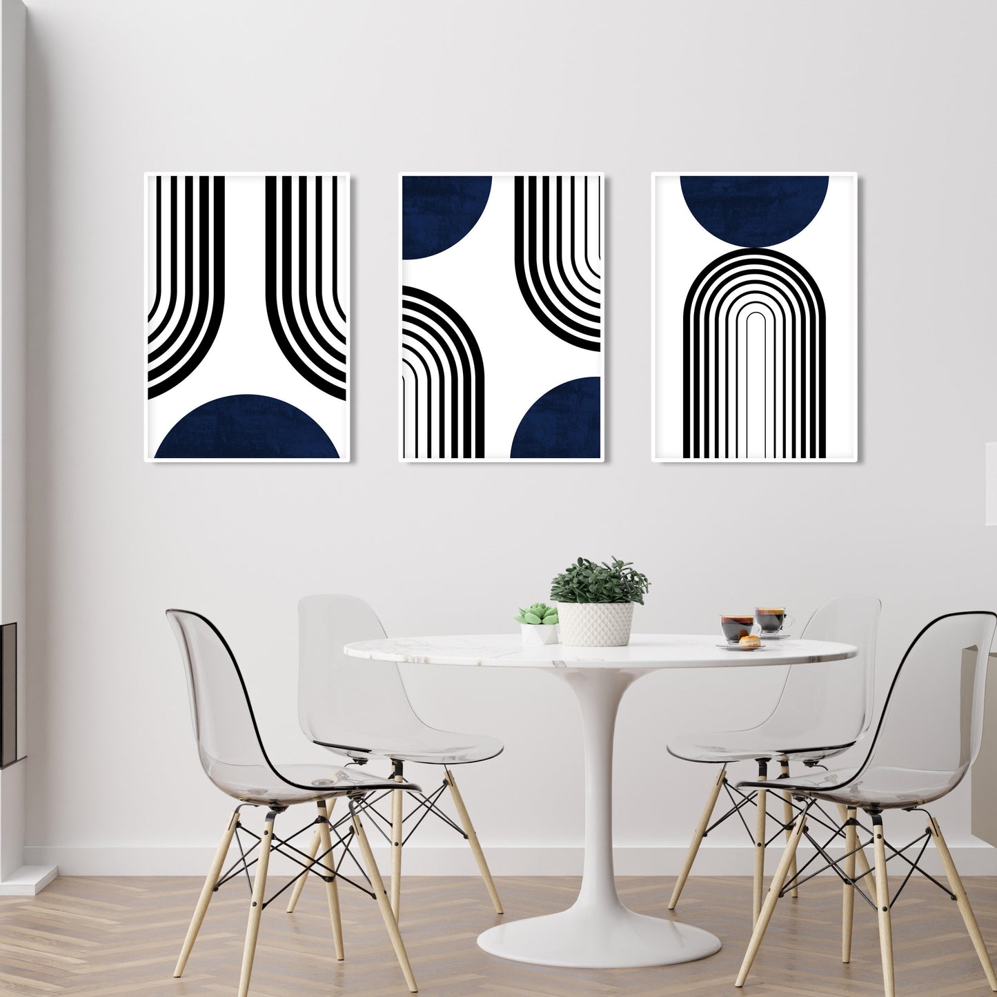 Set of three abstract navy and black mid-century prints displayed unframed above a dining table
