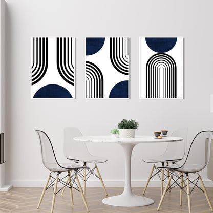 Set of three abstract navy and black mid-century prints displayed unframed above a dining table
