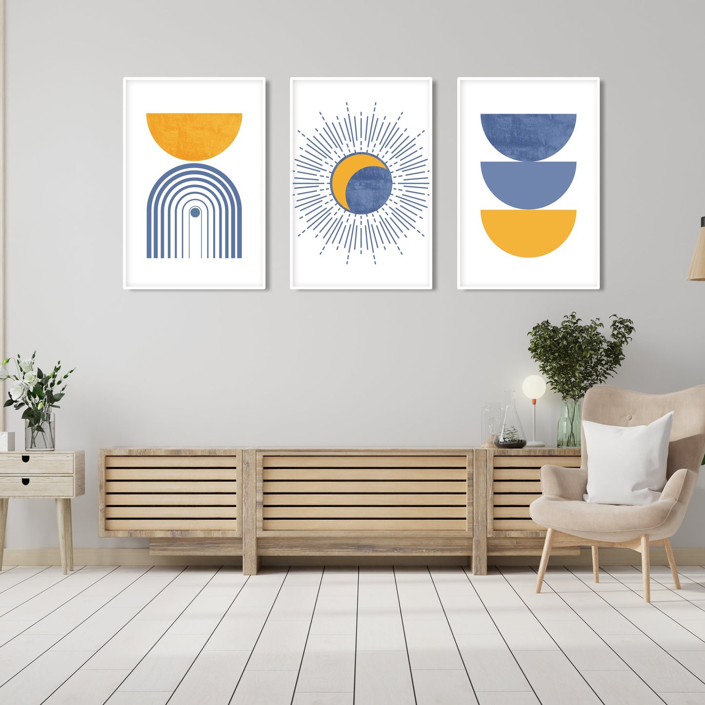 Abstract blue and mustard geometric art trio in white frames hung above a wood console
