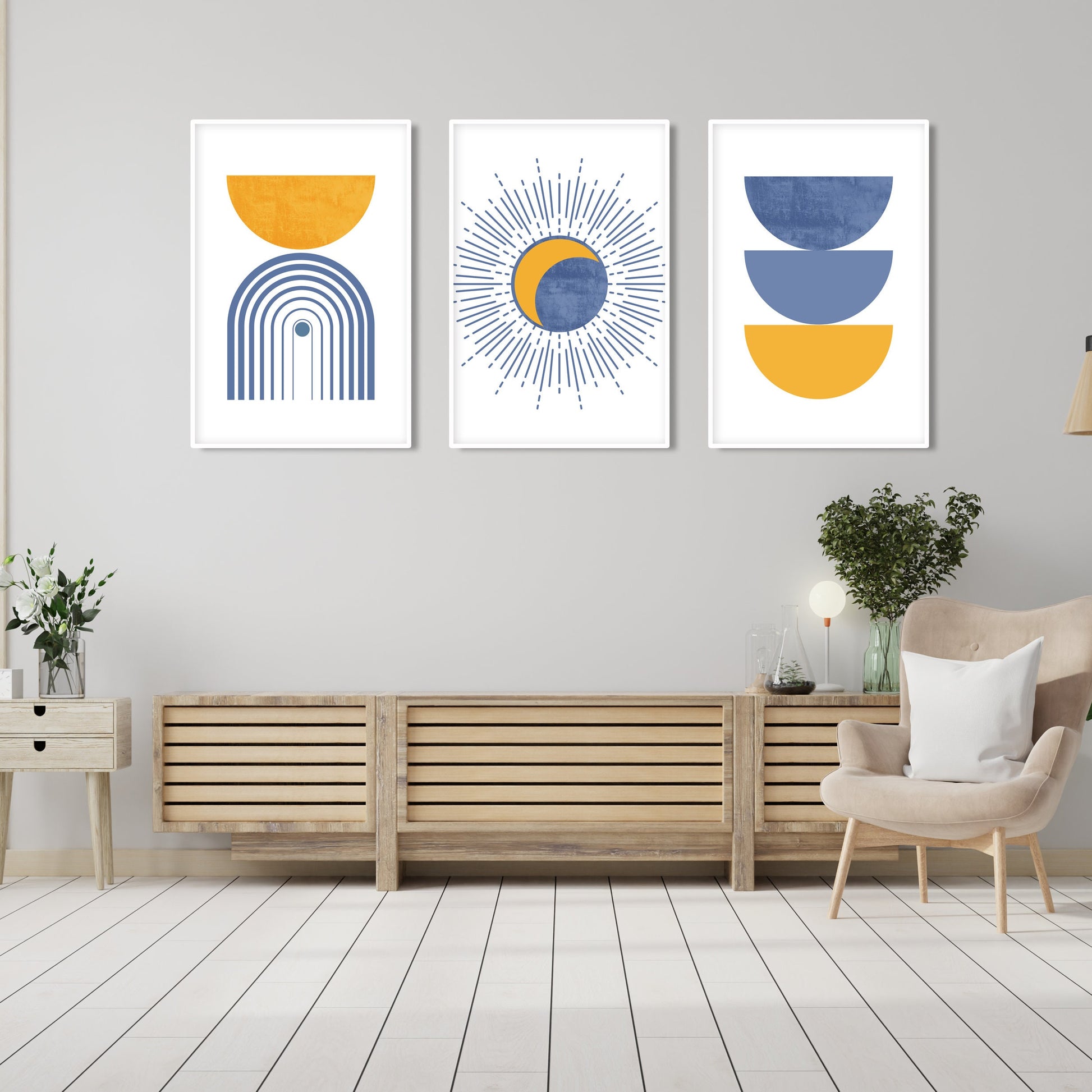 Abstract blue and mustard geometric art trio in white frames hung above a wood console