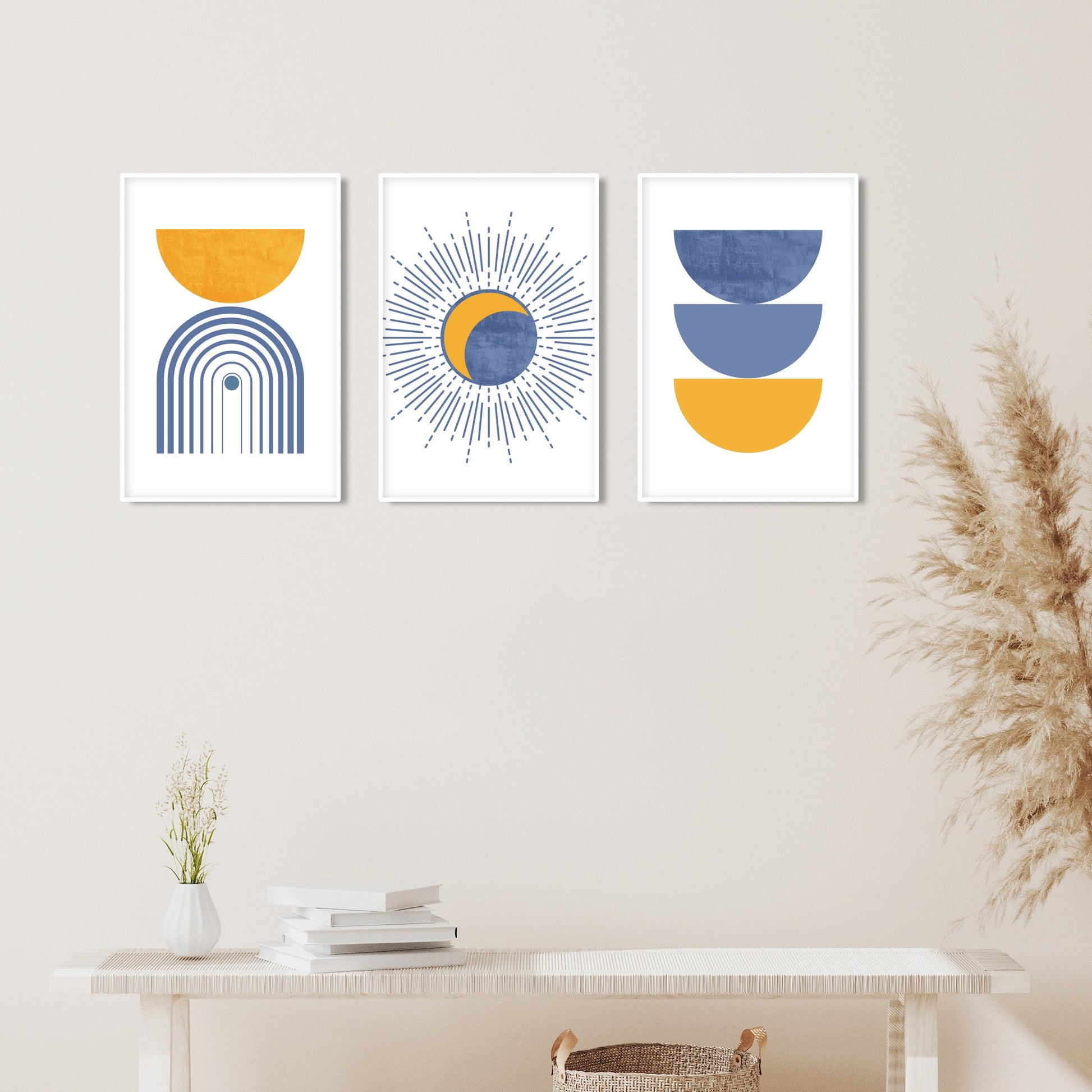 Abstract geometric boho prints in blue and mustard yellow, framed as a trio above a console