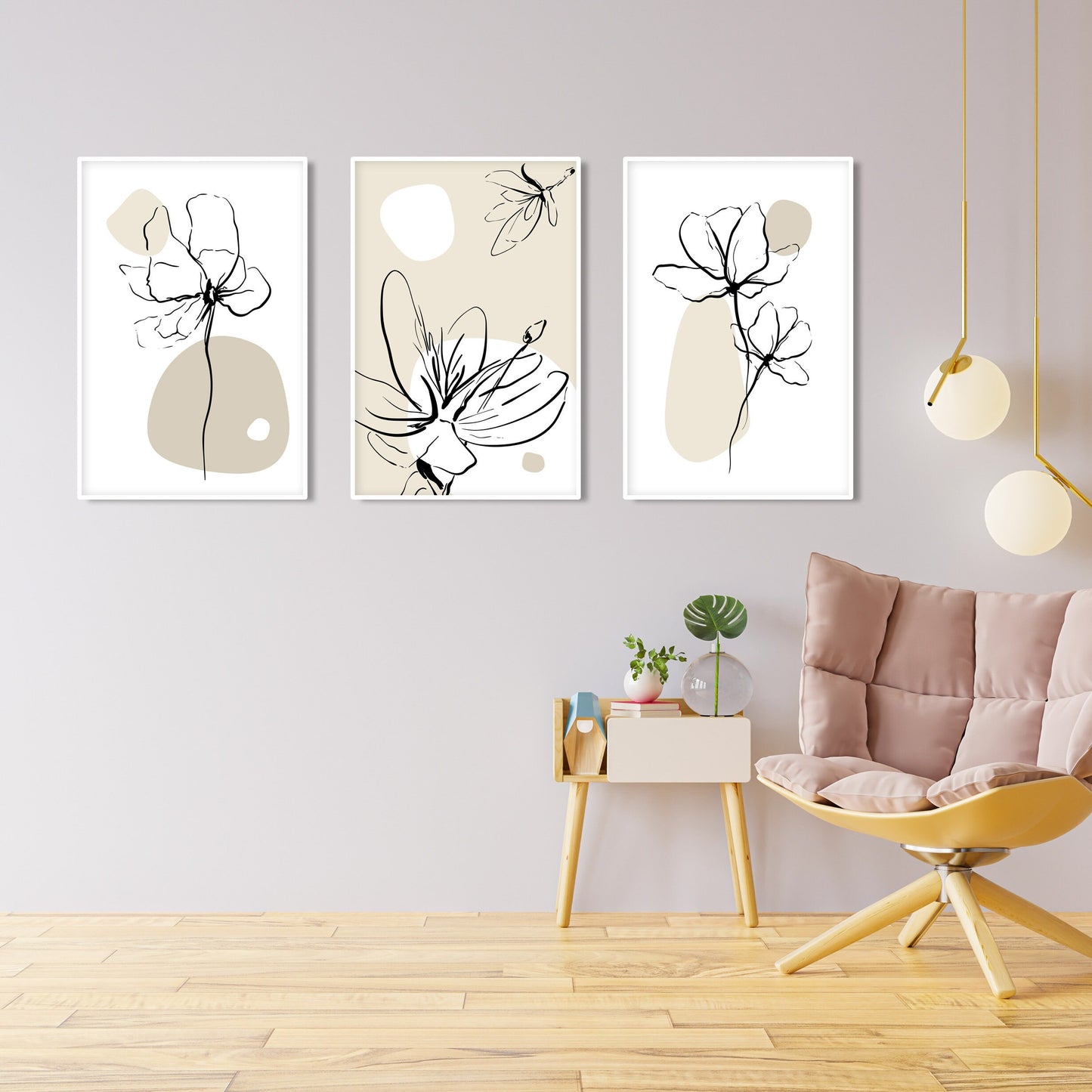 Three framed beige and black boho floral prints above a side table with books, plants, and ceramics