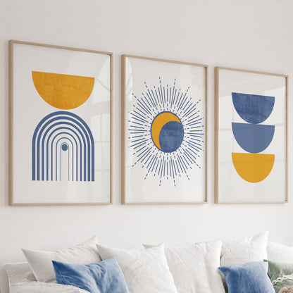 Boho geometric wall art trio in natural wood frames styled above a white sideboard