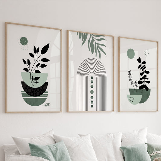 Three sage green minimalist boho prints in wood frames displayed above a sofa
