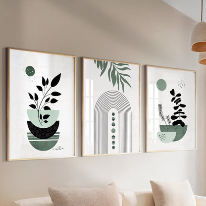 Three-piece sage green boho wall art set in light wood frames above a cream sofa