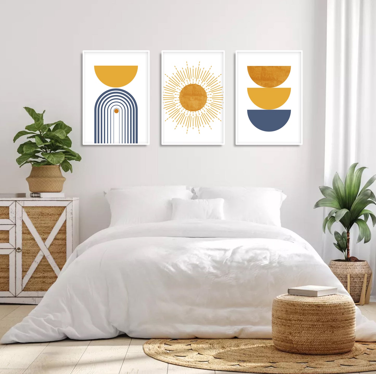 Abstract blue and mustard geometric prints in white frames above a bed, styled with plants and books.