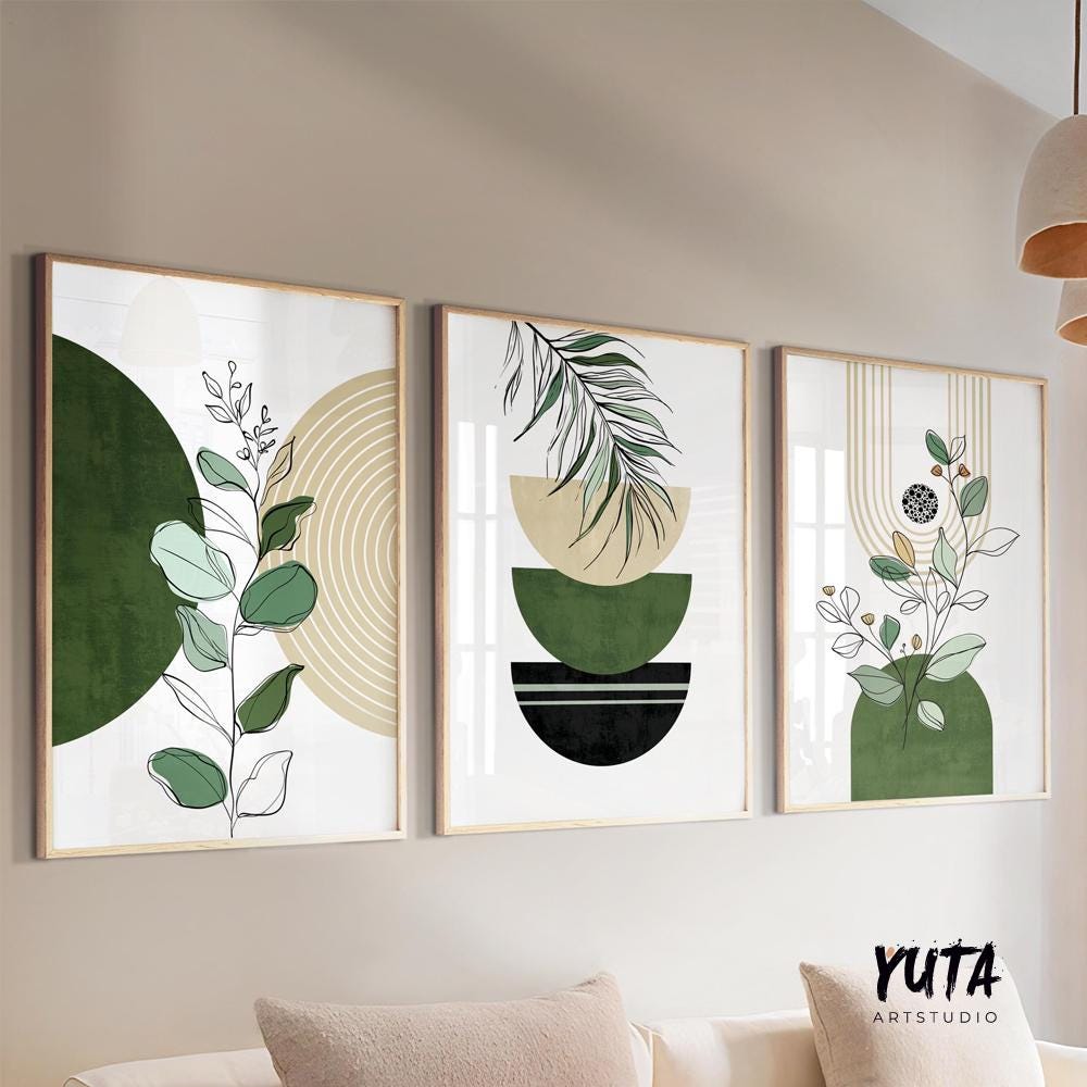 Abstract botanical prints with green and black shapes in light wood frames, displayed as a trio.