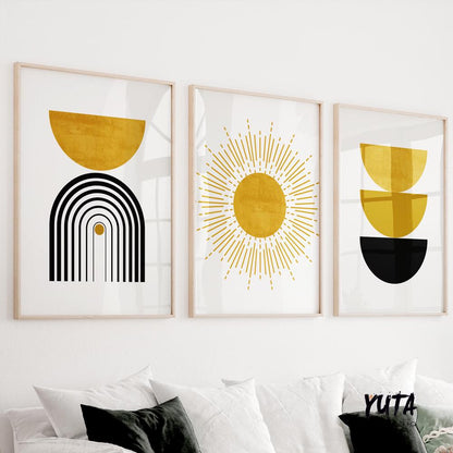 Framed abstract wall art set in black and mustard yellow shown above a white sofa for scale.