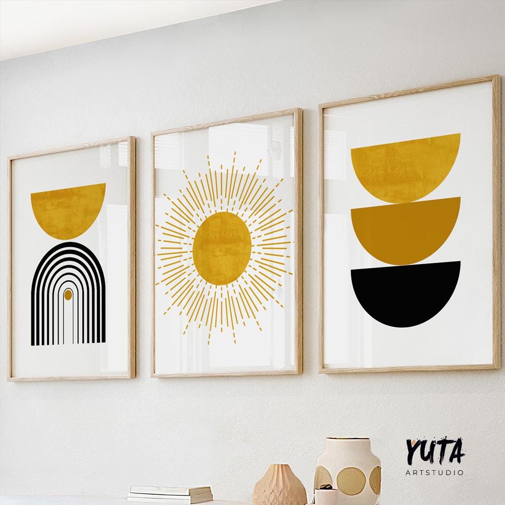 Three abstract boho prints in light wood frames displayed together above a white shelf