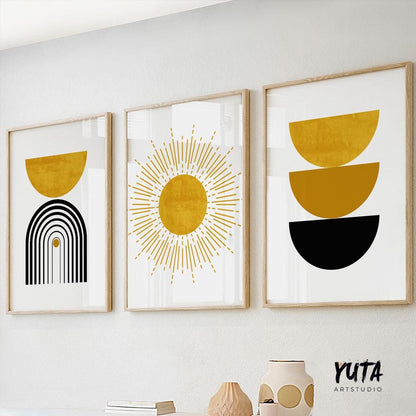 Three abstract boho prints in light wood frames displayed together above a white shelf