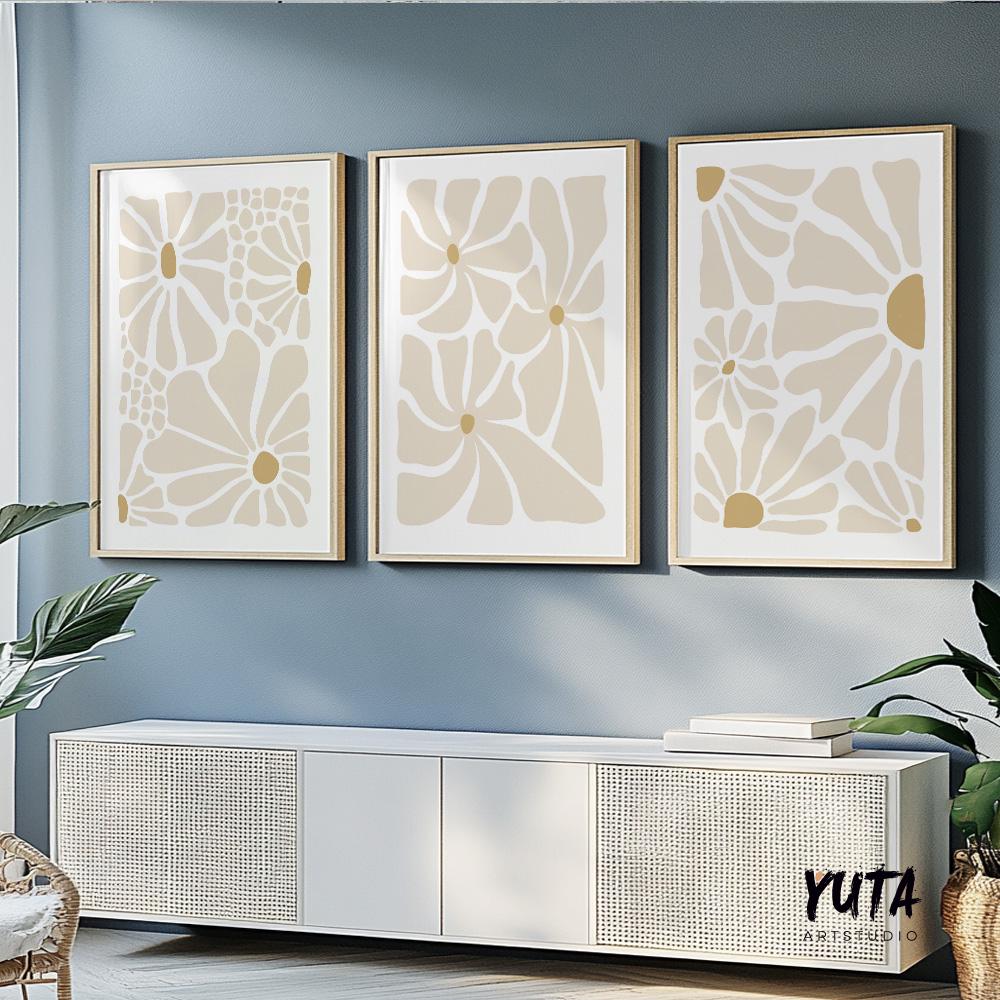Set of three abstract beige floral prints in light wood frames above a white console
