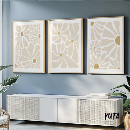 Set of three abstract beige floral prints in light wood frames above a white console