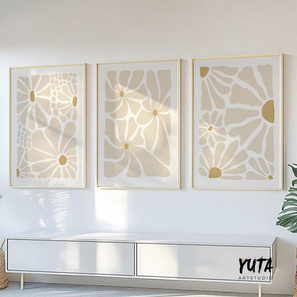 Minimalist beige floral prints in light wood frames centered above a white console table