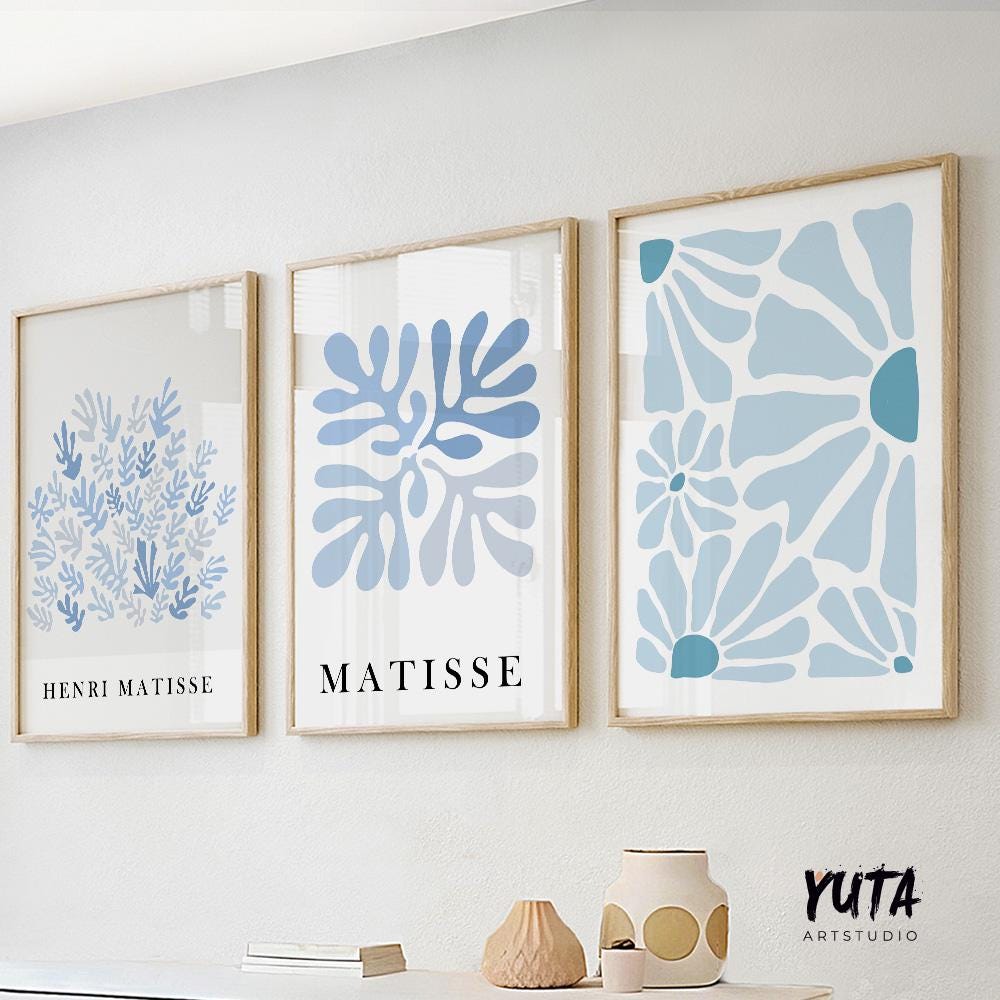 Framed blue Matisse-inspired abstract prints arranged as a trio above a white shelf