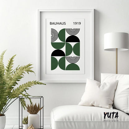 Geometric Bauhaus-inspired art print in black and dark green, framed above a white chair