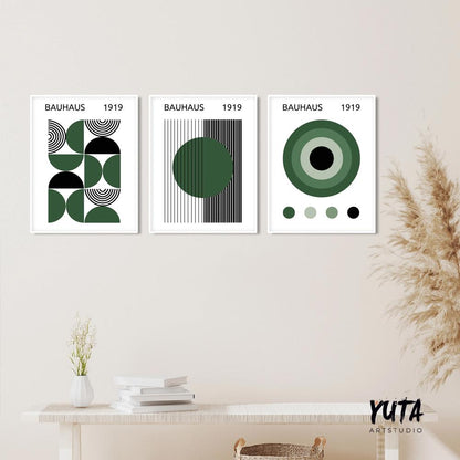 Trio of framed Bauhaus geometric prints in green, styled above a white console table.