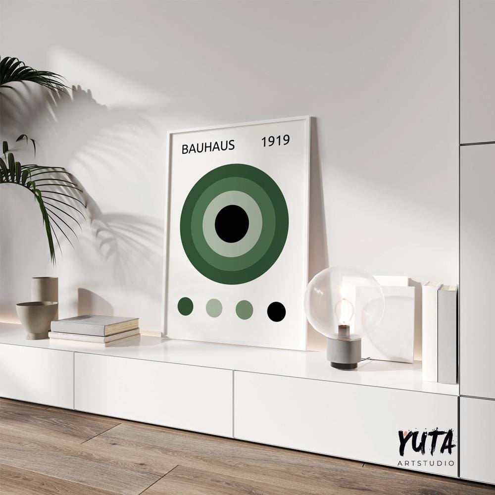 Mid-century modern Bauhaus print with dark green circles shown in 50x70 cm frame on cabinet