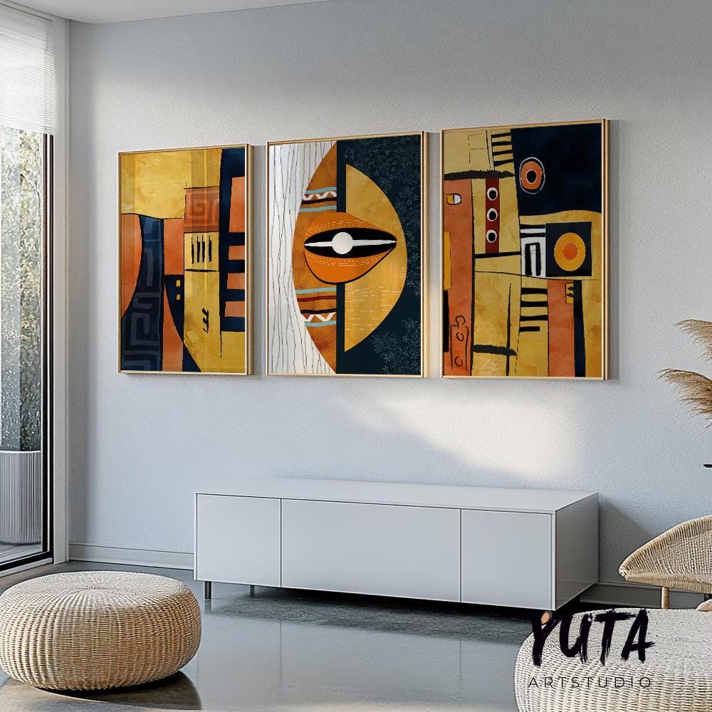 Framed geometric African abstract triptych in mid-century style above a white cabinet