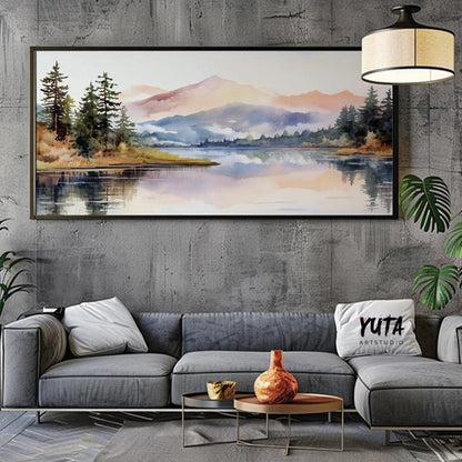 Pastel mountain landscape in a black frame centered above a modern grey sectional sofa