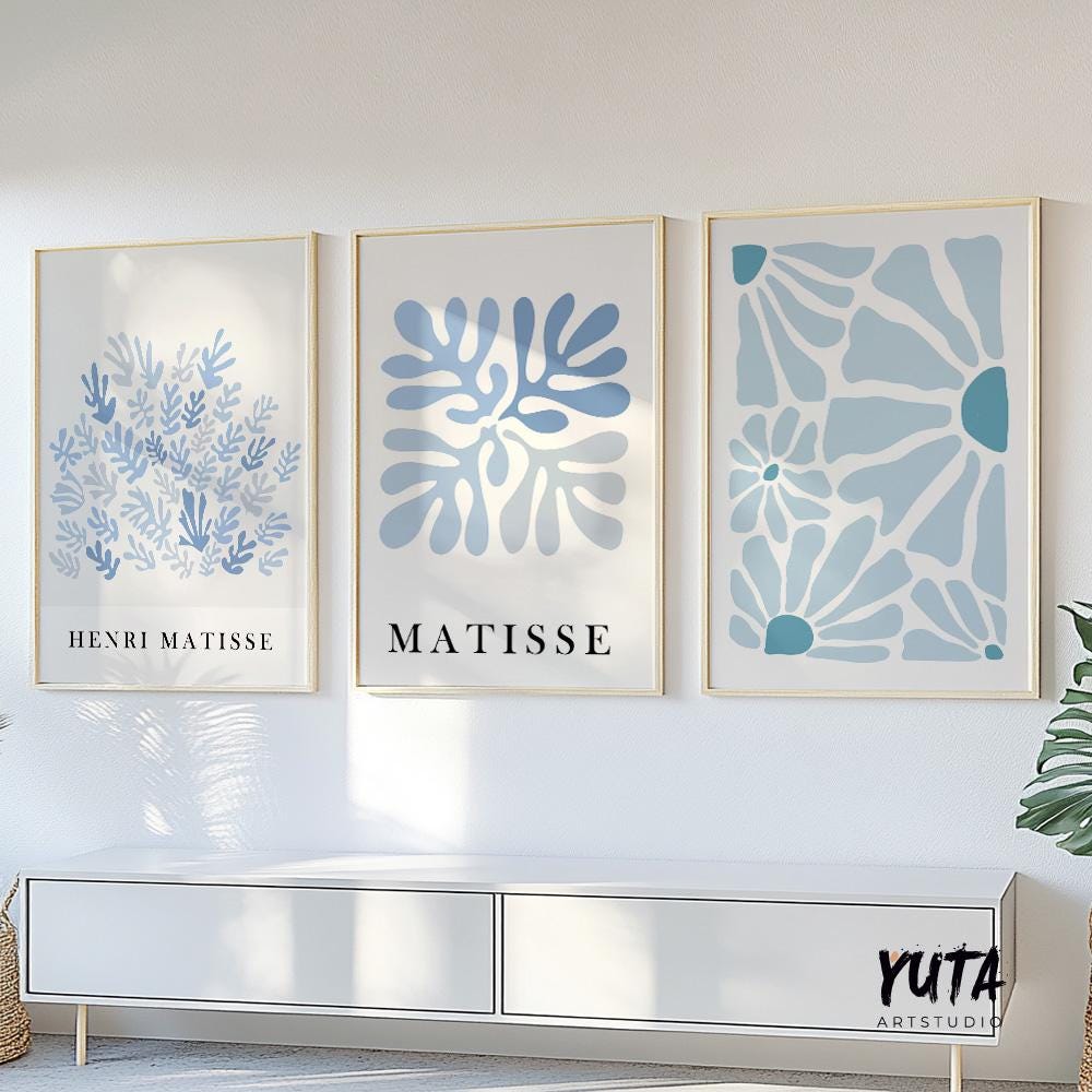 Three framed abstract blue Matisse prints arranged as a gallery wall in natural daylight