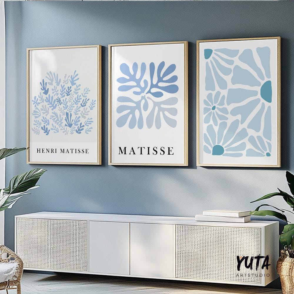 Abstract blue botanical prints in mid-century style, framed as a trio above a console