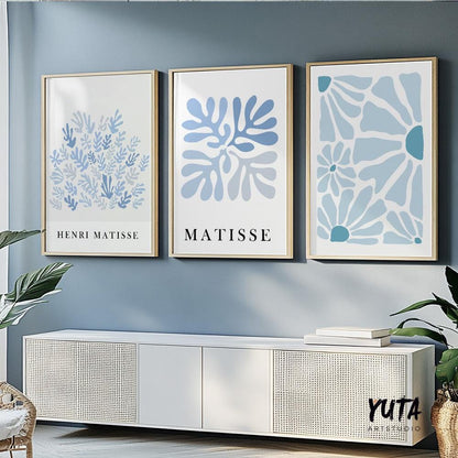 Abstract blue botanical prints in mid-century style, framed as a trio above a console
