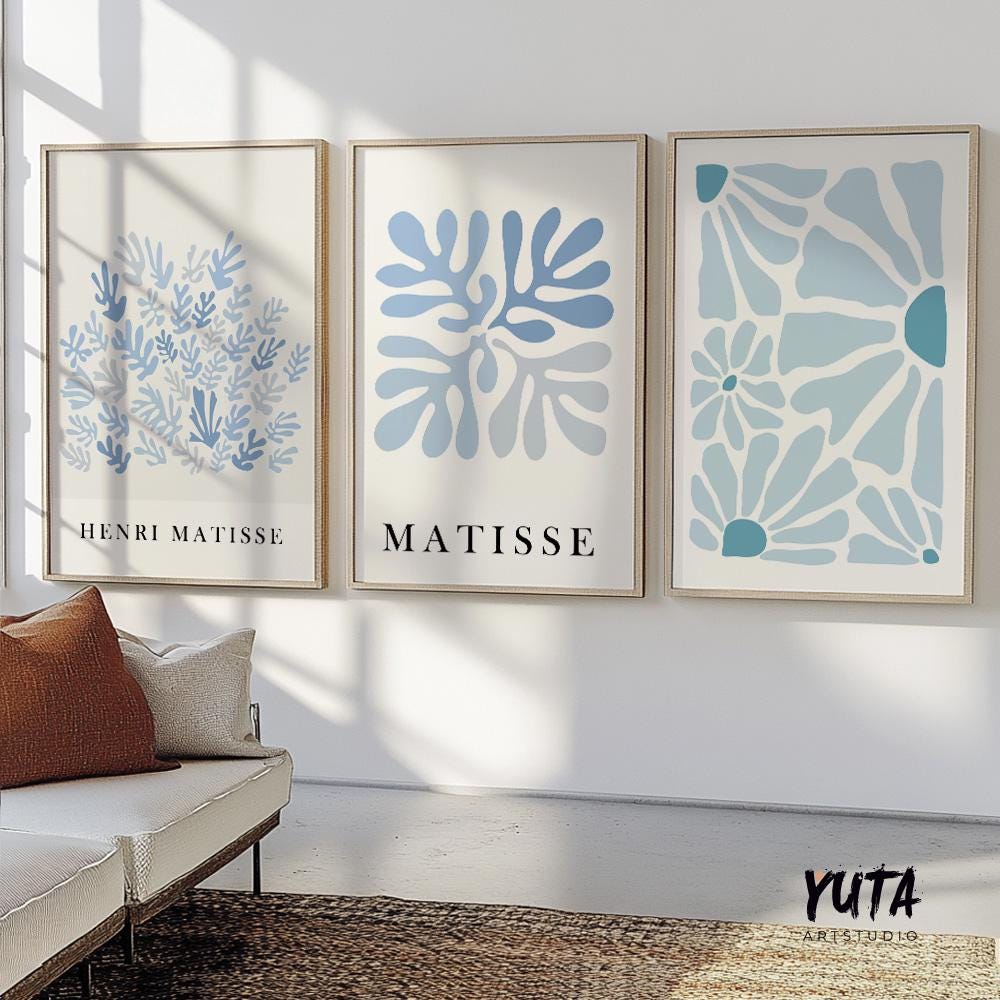 Three framed blue Matisse-inspired prints styled above a modern sideboard