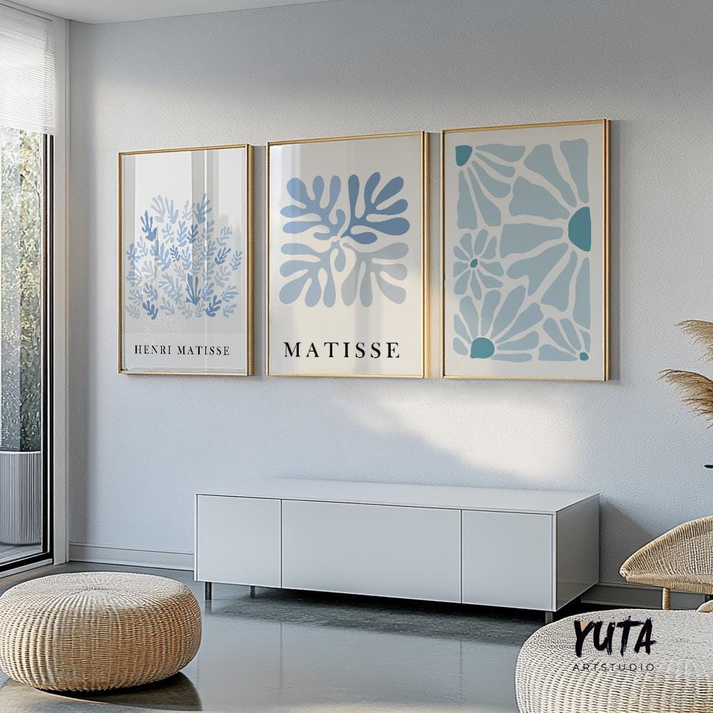 Three framed blue abstract Matisse prints displayed as a gallery set above a white console