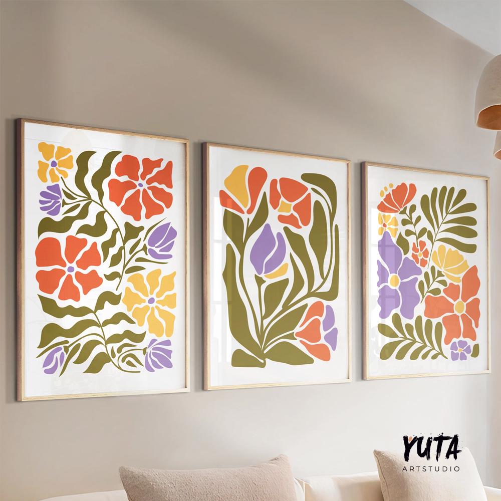 Three framed Matisse-inspired floral prints arranged above a light wood console