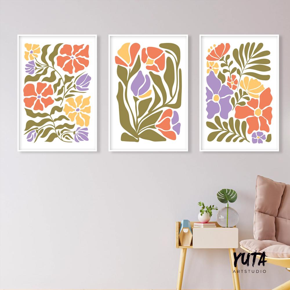 Three framed Matisse-inspired floral prints arranged as a gallery wall above a small table and chair.