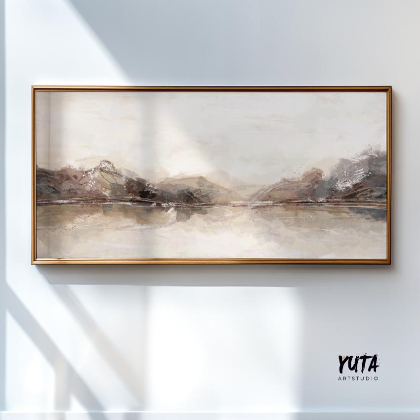 Panoramic abstract landscape in neutral tones framed in gold, hanging on a white wall.