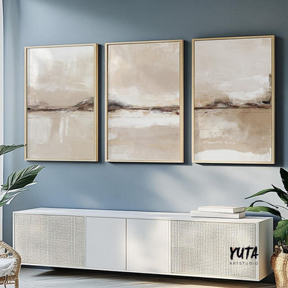 Neutral abstract landscapes in beige tones, framed as a triptych above a white console