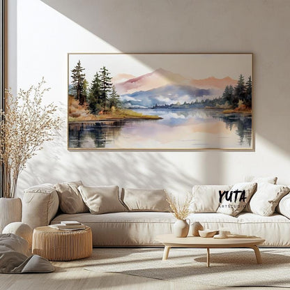 Framed pastel mountain landscape art above a neutral sofa, styled with ceramics and dried plants