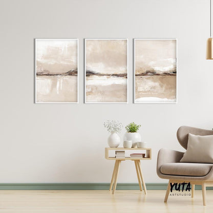 Set of three framed neutral abstract prints arranged above a minimalist console table