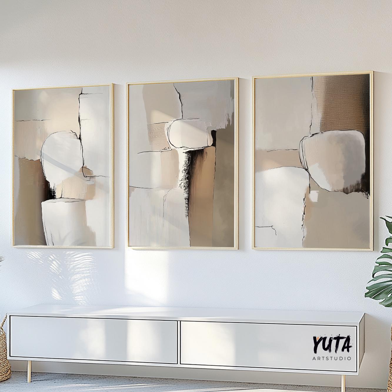 Neutral abstract triptych in beige and brown tones, framed and displayed above a white console.