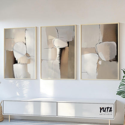 Neutral abstract triptych in beige and brown tones, framed and displayed above a white console.