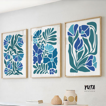 Abstract blue floral prints in wooden frames arranged as a three-piece gallery wall set